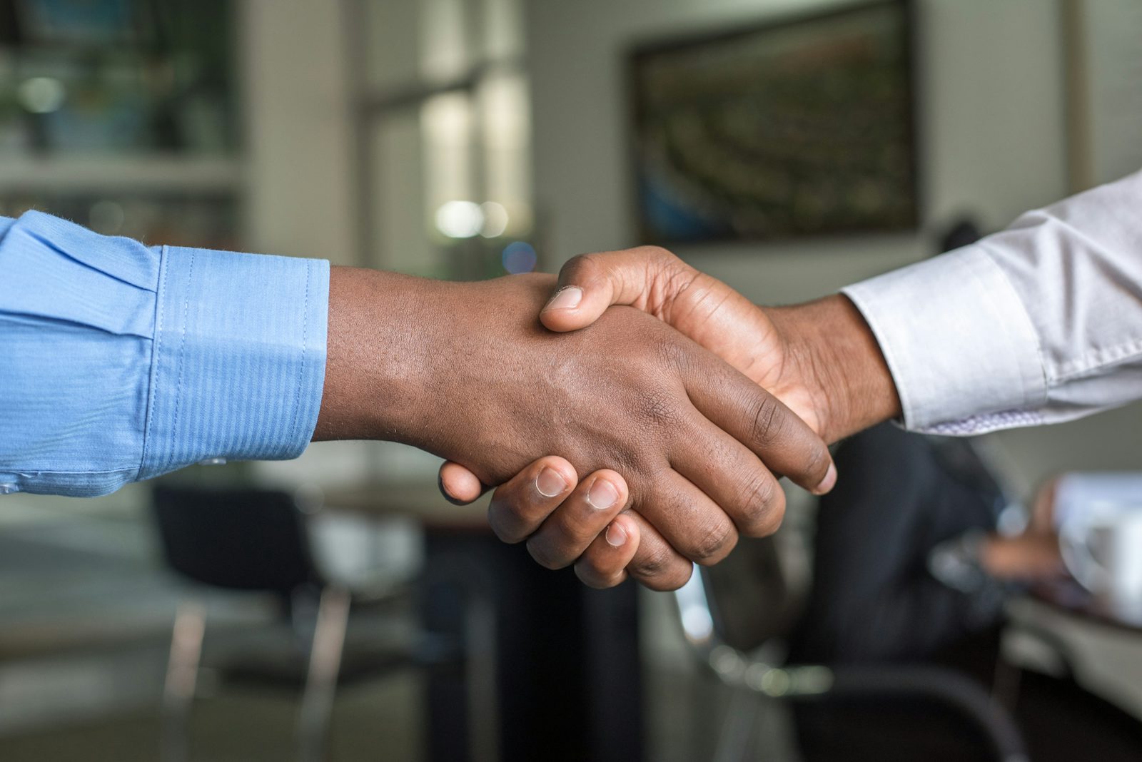 Two business partners shaking hands after agreeing project finance
